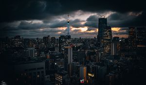 Preview wallpaper tower, buildings, lights, city, twilight, clouds