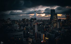 Preview wallpaper tower, buildings, lights, city, twilight, clouds