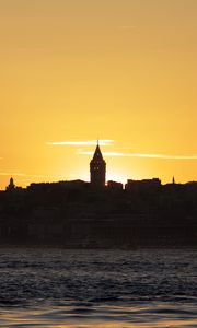 Preview wallpaper tower, buildings, silhouettes, sea, sunset