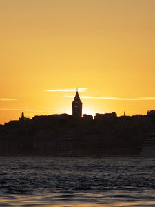 Preview wallpaper tower, buildings, silhouettes, sea, sunset