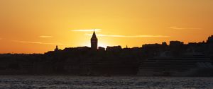 Preview wallpaper tower, buildings, silhouettes, sea, sunset