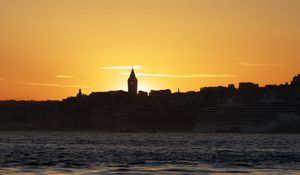 Preview wallpaper tower, buildings, silhouettes, sea, sunset