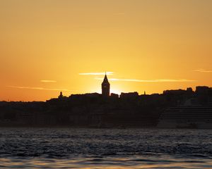 Preview wallpaper tower, buildings, silhouettes, sea, sunset
