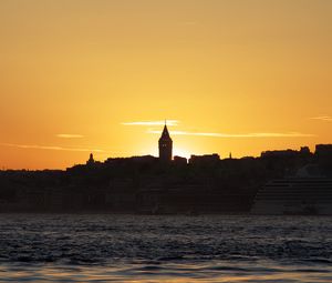 Preview wallpaper tower, buildings, silhouettes, sea, sunset