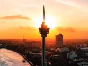 Preview wallpaper tower, city, sunset, coast