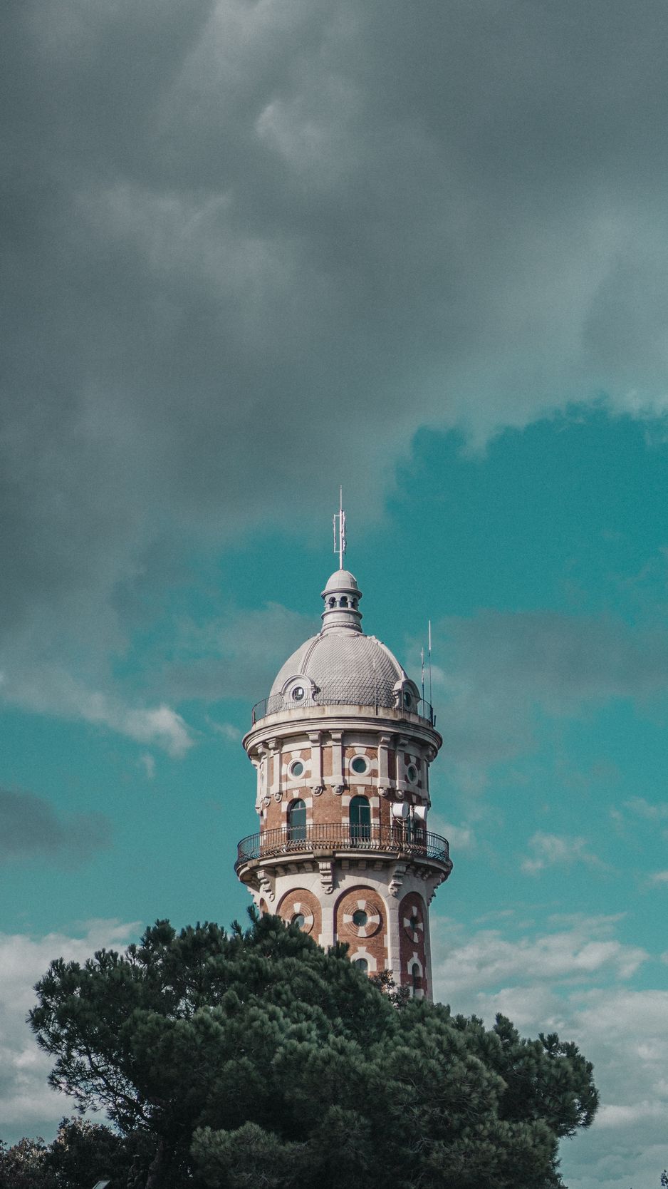 Download wallpaper 938x1668 tower, clouds, trees, barcelona, spain iphone  8/7/6s/6 for parallax hd background
