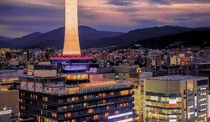 Preview wallpaper tower, glow, lights, buildings, twilight, city