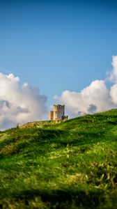 Preview wallpaper tower, hill, grass, clouds, nature