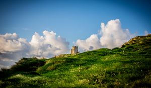 Preview wallpaper tower, hill, grass, clouds, nature