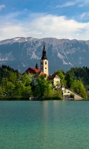 Preview wallpaper tower, house, mountains, trees, lake