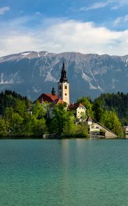 Preview wallpaper tower, house, mountains, trees, lake