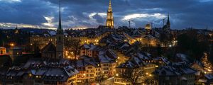 Preview wallpaper tower, houses, lights, buildings, clouds, twilight, city