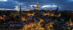 Preview wallpaper tower, houses, lights, buildings, clouds, twilight, city