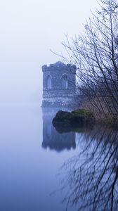 Preview wallpaper tower, lake, reflection, tree, branches, fog