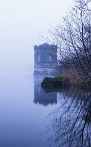 Preview wallpaper tower, lake, reflection, tree, branches, fog