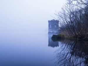 Preview wallpaper tower, lake, reflection, tree, branches, fog