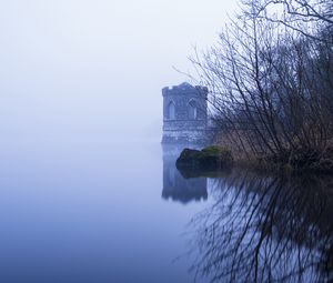 Preview wallpaper tower, lake, reflection, tree, branches, fog