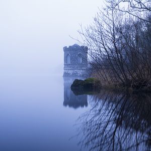 Preview wallpaper tower, lake, reflection, tree, branches, fog