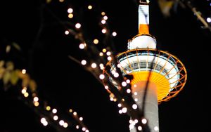 Preview wallpaper tower, lights, bokeh, branches, dark