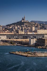 Preview wallpaper tower, mountain, buildings, city, sea, pier