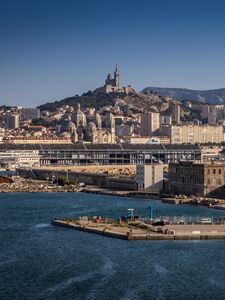 Preview wallpaper tower, mountain, buildings, city, sea, pier