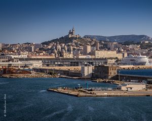 Preview wallpaper tower, mountain, buildings, city, sea, pier