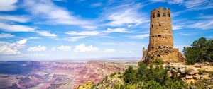 Preview wallpaper tower, mountains, rocks, clouds, nature