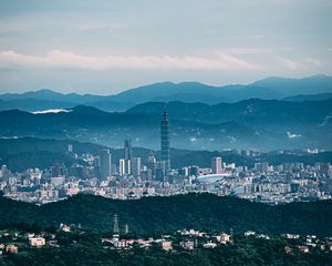 Preview wallpaper tower, skyscraper, city, mountains, hills