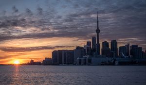 Preview wallpaper tower, skyscrapers, buildings, city, sea, sunrise