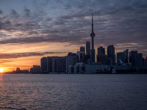 Preview wallpaper tower, skyscrapers, buildings, city, sea, sunrise