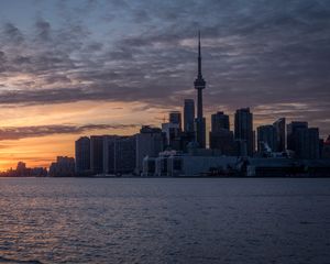 Preview wallpaper tower, skyscrapers, buildings, city, sea, sunrise