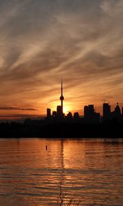 Preview wallpaper tower, skyscrapers, buildings, silhouettes, sea, twilight