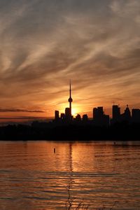 Preview wallpaper tower, skyscrapers, buildings, silhouettes, sea, twilight