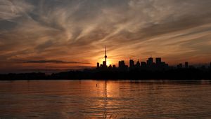 Preview wallpaper tower, skyscrapers, buildings, silhouettes, sea, twilight