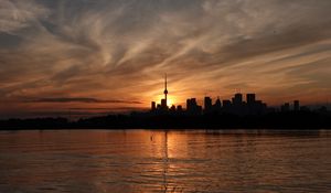 Preview wallpaper tower, skyscrapers, buildings, silhouettes, sea, twilight