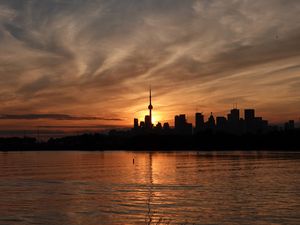 Preview wallpaper tower, skyscrapers, buildings, silhouettes, sea, twilight