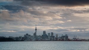 Preview wallpaper tower, skyscrapers, buildings, city, sea, clouds