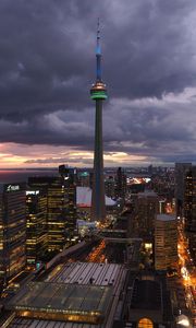 Preview wallpaper tower, skyscrapers, buildings, lights, city, twilight, clouds