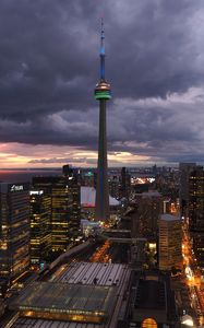 Preview wallpaper tower, skyscrapers, buildings, lights, city, twilight, clouds