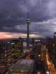 Preview wallpaper tower, skyscrapers, buildings, lights, city, twilight, clouds