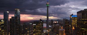 Preview wallpaper tower, skyscrapers, buildings, lights, city, twilight, clouds