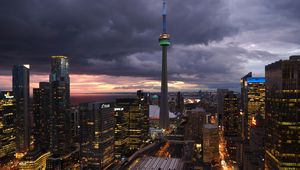 Preview wallpaper tower, skyscrapers, buildings, lights, city, twilight, clouds