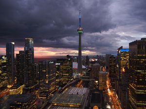 Preview wallpaper tower, skyscrapers, buildings, lights, city, twilight, clouds