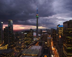 Preview wallpaper tower, skyscrapers, buildings, lights, city, twilight, clouds