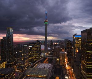 Preview wallpaper tower, skyscrapers, buildings, lights, city, twilight, clouds