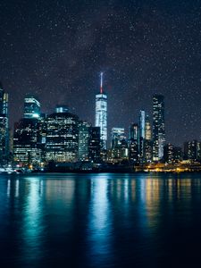 Preview wallpaper tower, skyscrapers, lights, night, river, starry sky