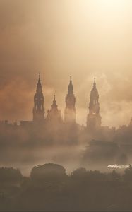 Preview wallpaper towers, buildings, fog, trees