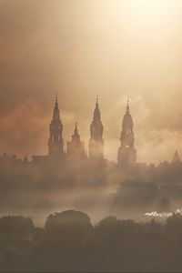 Preview wallpaper towers, buildings, fog, trees