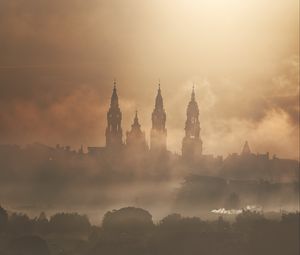 Preview wallpaper towers, buildings, fog, trees