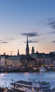 Preview wallpaper towers, buildings, lights, river, boat, twilight